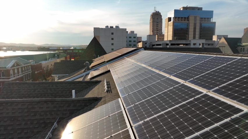 Renewable energy in American city. Rooftop solar panel array collects light. Clean green electricity. Aerial view. Royalty-Free Stock Footage #1097412079