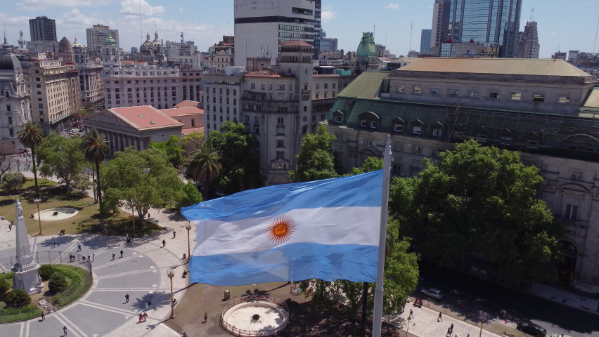 Aerial push-out of flag of Argentina at Plazo de Mayo in Buenos Aires