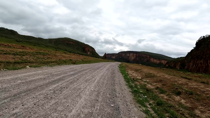 POV shot. Safari riding a bike in Hells Gate National Park, Kenya