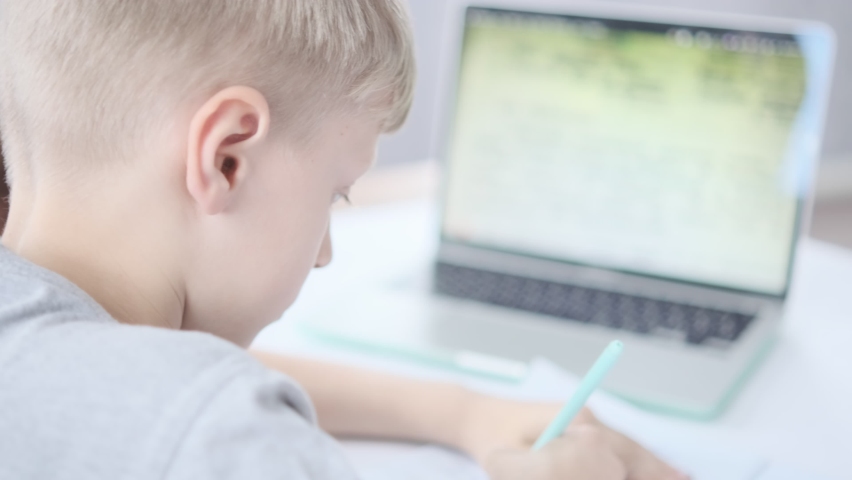Boy studying online at mockup laptop at home. Student doing homework. Schoolboy Online training. Remote school. Coronavirus. School distance education. E-Learning. Education of future | Shutterstock HD Video #1097413961