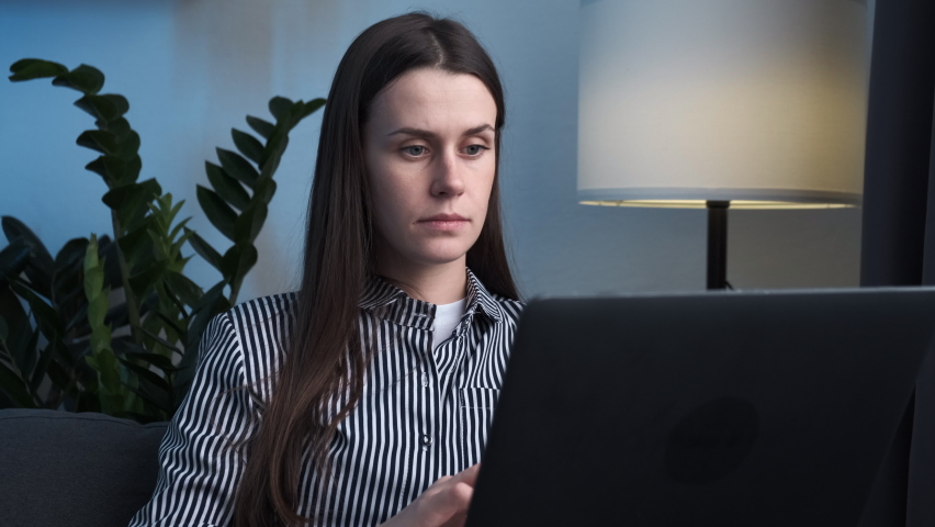 Close up of tired brunette woman massaging temples, suffering from headache after computer work, sitting on sofa with laptop at home. Exhausted female touching head, relieving pain, migraine concept | Shutterstock HD Video #1097414081