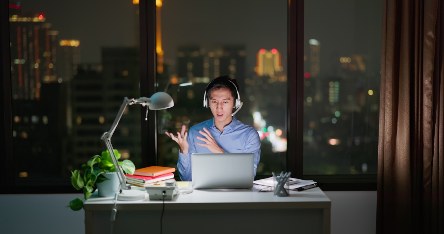 Asian business man sitting in office participating video conference at night | Shutterstock HD Video #1097416939