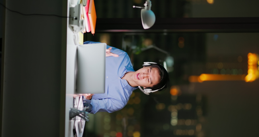 Vertical shot - Asian business man sitting in office participating video conference at night | Shutterstock HD Video #1097416945