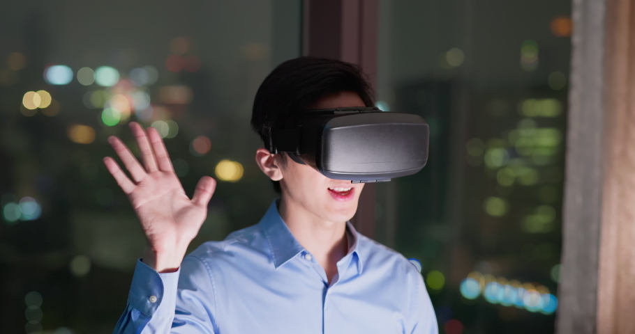 Close up - Asian business man sitting in office participating video conference using VR technology at night | Shutterstock HD Video #1097416947