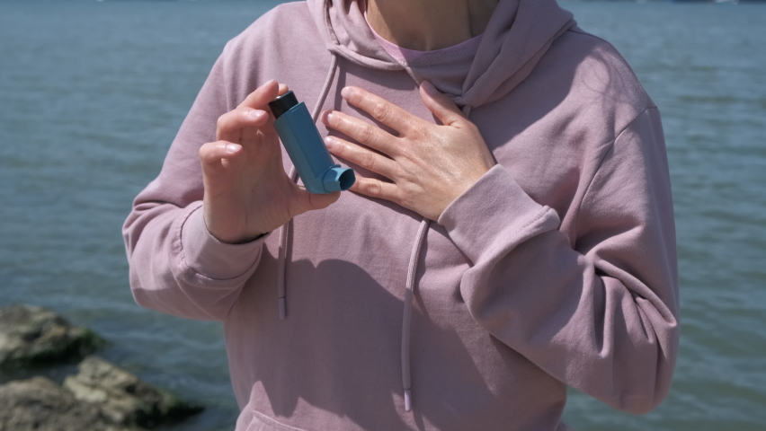 Asthma attack. The woman is choking and using an inhaler. | Shutterstock HD Video #1097418049
