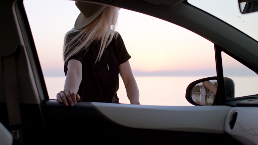 View from car of woman walking towards sunset during road trip stop. | Shutterstock HD Video #1097418787
