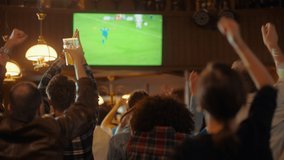 Group of Multicultural Friends Watching a Live Soccer Match on TV in a Sports Bar. Happy Fans Cheering and Shouting. Young People Celebrating When Team Scores a Goal and Wins the Football World Cup. - Powered by Shutterstock - Get 15% off with code: PIKWIZARD15