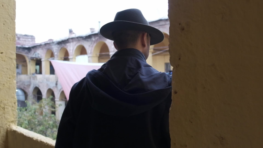 a man looking around at an old inn