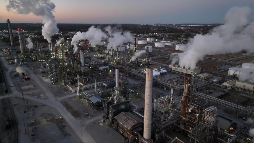 Oil and gas petroleum refinery in USA. Aerial at daybreak. Air quality and environmental impact theme. Royalty-Free Stock Footage #1097424949
