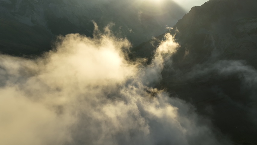 aerial view over clouds during sunrise French alps mountains mystical light