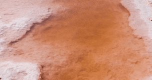 Closeup detailed shot of unrefined salt in Salt lake in Tunisia Chott el Djerid red color of water from the salt minerals. Largest salt lake in the Sahara Desert. - Powered by Shutterstock - Get 15% off with code: PIKWIZARD15