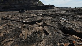 Drone shot skimming Rocks and rock pools at low tide