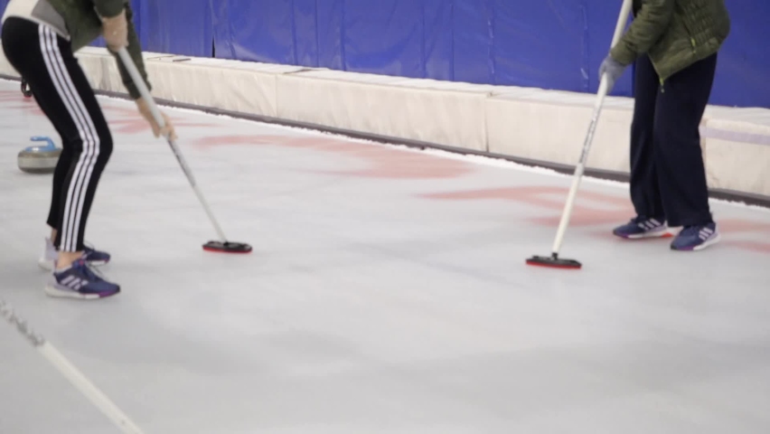 Unrecognizable people are playing curling. Royalty-Free Stock Footage #1097436231