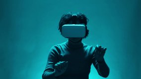 Woman scrolling and sliding invisible screen and clicking checking on different options. Adult female playing VR video games. Cinematic Portrait of Stylish Mature Woman Using Virtual Reality Headset