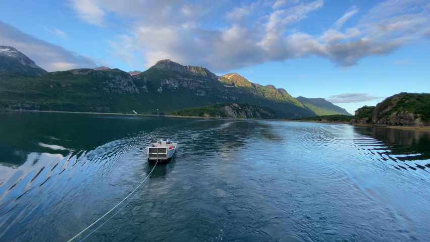 
Skiff being pulled behind boat at Geographic Harbor in Katmai National Park Alaska