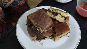 Famous and super delicious Indonesian cake desert called Martabak Terang Bulan sweet stuffed pancake, and martabak telor savory
