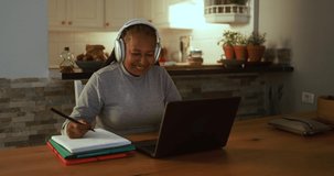 Senior woman working with laptop computer from home - Elderly lifestyle and technology concept 