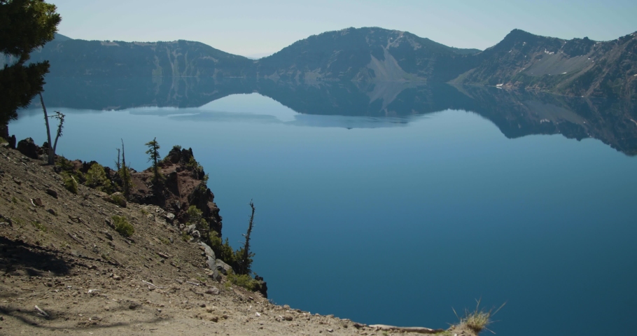 Pan of lake surrounded by mountains with volcano island in the middle