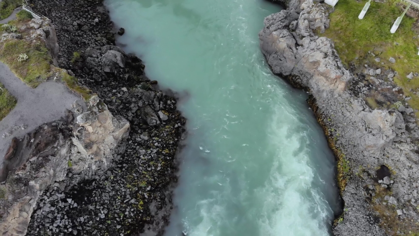 Top down aerial of Godafoss glacier blue green waterfall in Iceland
