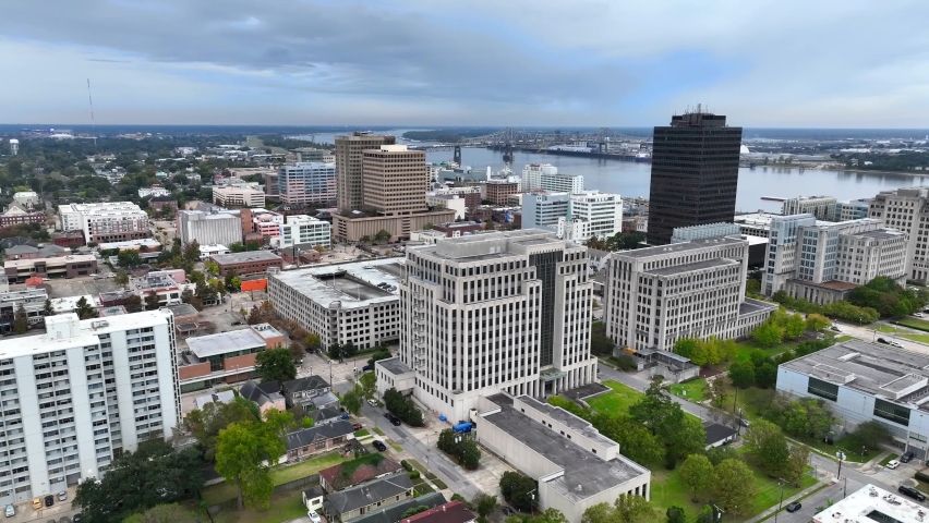 Aerial reveal of downtown Baton Rouge Louisiana and Mississippi River on overcast evening.
