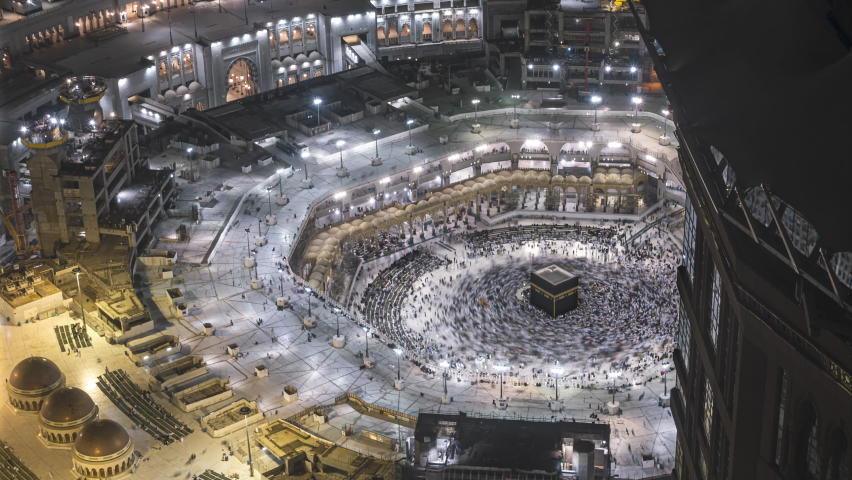 Night time lapse wide angle of Muslim pilgrims circling around the holy Kaaba at dawn and praying inside al Masjid al Haram in Mecca, Saudi Arabia. Prores 4KUHD Royalty-Free Stock Footage #1097451043
