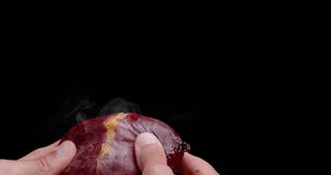 4K slow motion video of a baked potato slowly cracked open and steam coming out.