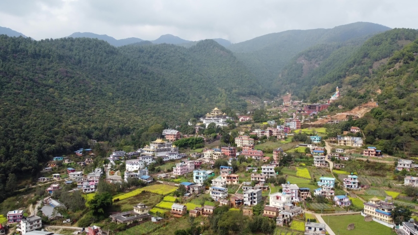 A beautiful aerial view of the small town of Dakshinkali, Nepal surrounded by fields and the foothills of the Himalaya Mountains.