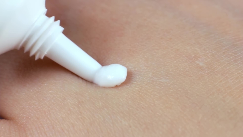 A white moisturizing cream applying on woman hand skin close up on light background | Shutterstock HD Video #1097461187
