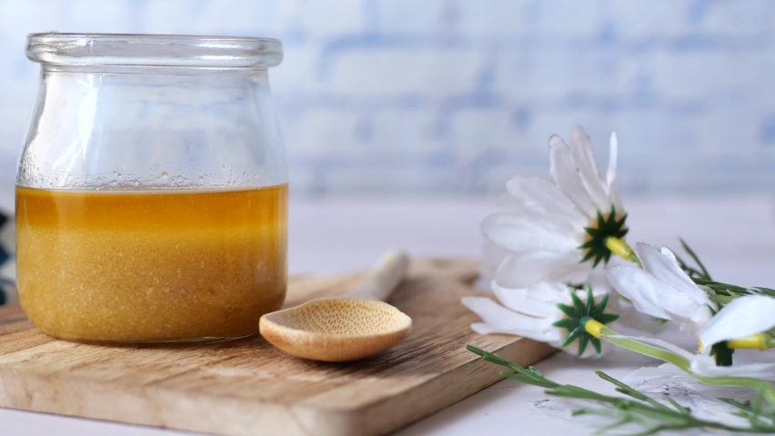 Homemade ghee in container on a table , | Shutterstock HD Video #1097464069