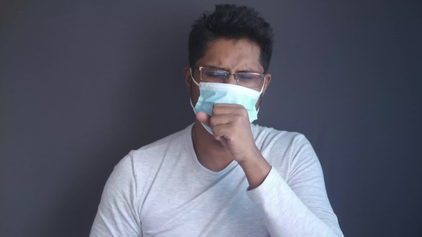  young sick man coughing and sneezes 