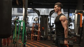 Athlete exercising with dumbbells in indoor gym. Fit man doing biceps triceps curls workout in gym - Powered by Shutterstock - Get 15% off with code: PIKWIZARD15