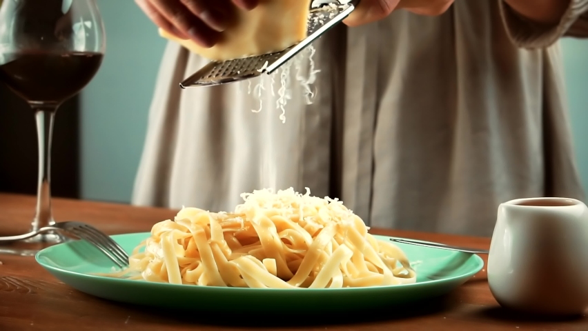 Chef Grating Pecorino Cheese On Spaghetti In Plate. Cook Grated Cheese To Pasta. Cooking Spaghetti With Sause In Restaurant. Chef Garnishing Delicious Pasta With Parmesan Cheese. Italian Pasta Cuisine Royalty-Free Stock Footage #1097467047
