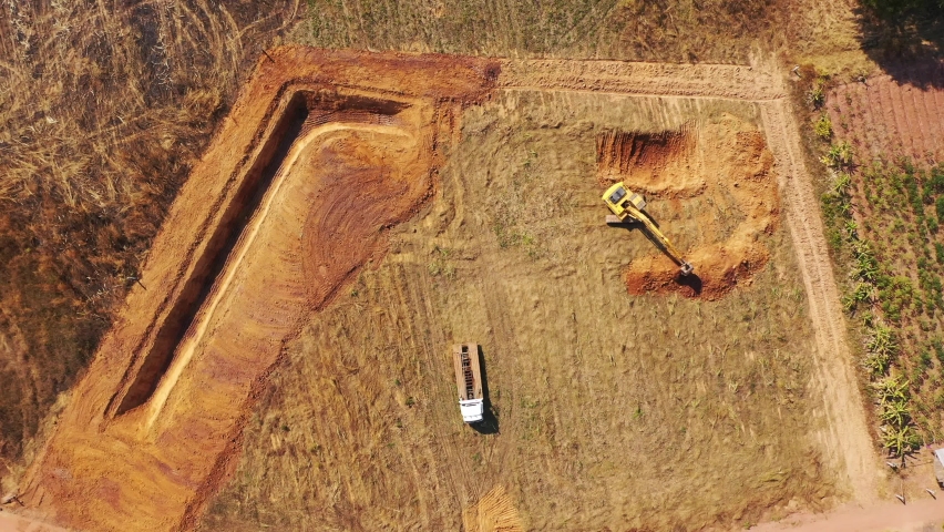 Aerial view, A trackhoe is digging the pond. | Shutterstock HD Video #1097471421