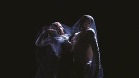 Passion in dark. Couple of contemp style dancers in dramatic performance dancing isolated on black background. Human emotions, art, beauty and music concept. Video, 4K
