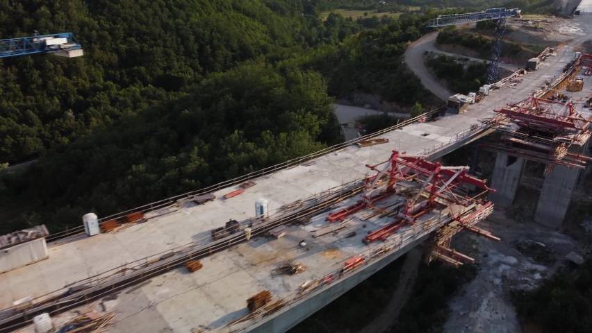 Highway bridge under construction. Aerial view of nes road. Freeway being built on a mountain terrain. Royalty-Free Stock Footage #1097483597