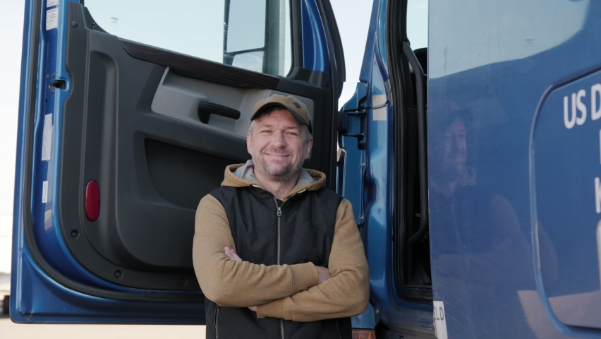 Portrait of truck driver . The driver looks at the camera