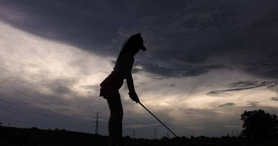 Silhouette Young Asian female golfer Swing Drive Golf, wide angle shot slow motion 4k video
