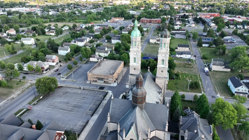 An aerial view of the Saint Stanislaus B and M Roman Catholic Church spires in Buffalo, New York in the light of the setting sun.