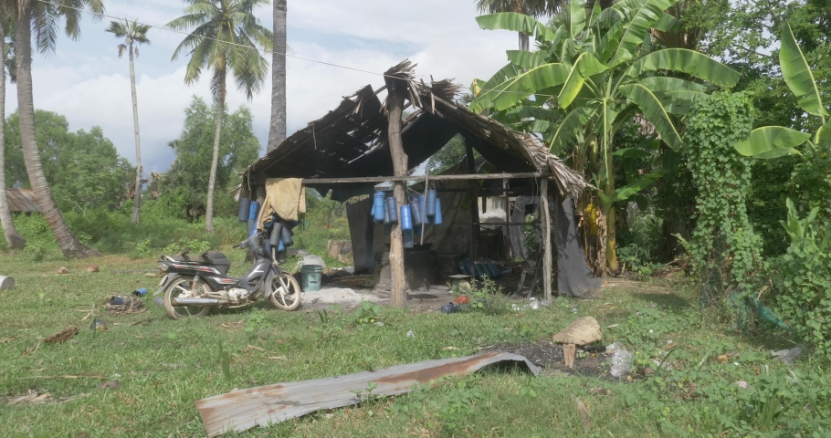 Front view of a small workshop in rural area. Smoky sweetest from palm sugar boiled in large pot