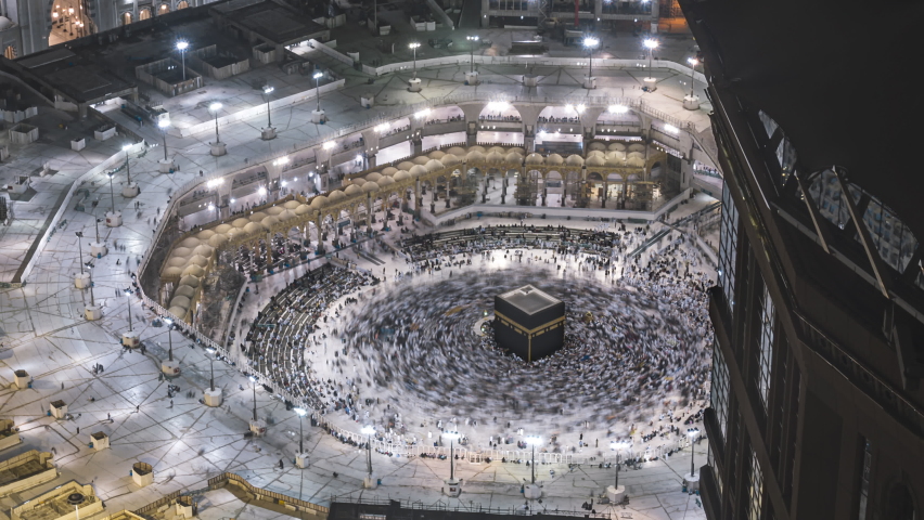 Night time lapse wide angle of Muslim pilgrims circling around the holy Kaaba at evening and praying inside al Masjid al Haram in Mecca, Saudi Arabia. Zoom out motion timelapse. Prores 4KUHD | Shutterstock HD Video #1097491039