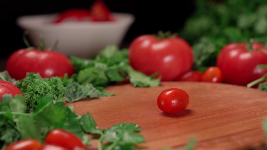 Man is slowly cutting a ripe cherry tomato . | Shutterstock HD Video #1097491103