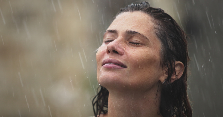 Close up Portrait of Female Enjoying Summer Tropical Rain, Woman Meditating with Eyes Closed Standing Outdoor, Woman Face with Great Positive Emotions, Smiling Charmingly, Exploring Spirituality.