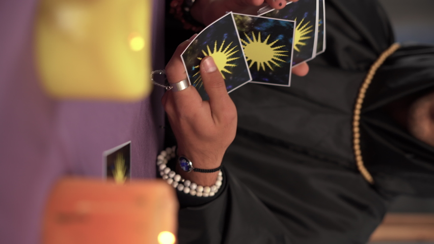 Close-up of a male fortune teller reading tarot cards. | Shutterstock HD Video #1097493447
