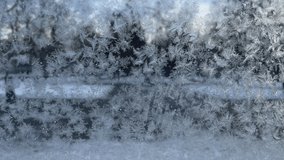 A person walks past a beautiful pattern of snowflakes on glass on a frosty day in winter - Powered by Shutterstock - Get 15% off with code: PIKWIZARD15