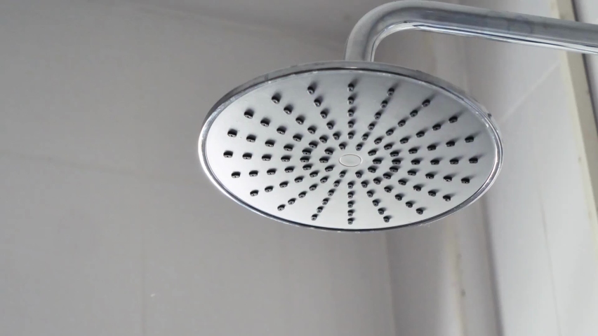 Motion Shot of Water Falling From Shower Head Close-up of turning on water sprays. | Shutterstock HD Video #1097499411