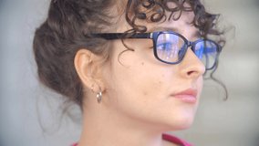 Portrait of young Ukrainian brunette female. Natural looking white woman in eye glasses posing for video clip