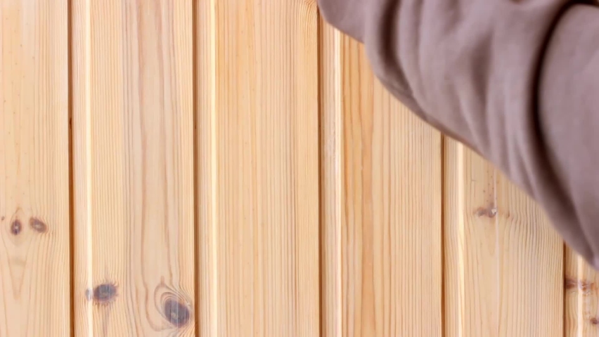 Painting brush with impregnation for wood cover the wooden plank wall during the interior renovation in home Royalty-Free Stock Footage #1097500035