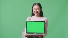 Asian Woman Student Showing Mock Up Laptop Green Screen On Green Screen Studio
 - Powered by Shutterstock - Get 15% off with code: PIKWIZARD15