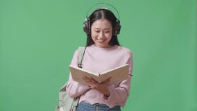 Asian Woman Student Reading Book And Listening Music With Headphones On Green Screen Studio
 - Powered by Shutterstock - Get 15% off with code: PIKWIZARD15
