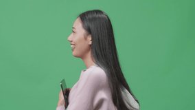 Side View Of Smiling Asian Woman Student Holding Tablet And Walking On Green Screen Studio
 - Powered by Shutterstock - Get 15% off with code: PIKWIZARD15